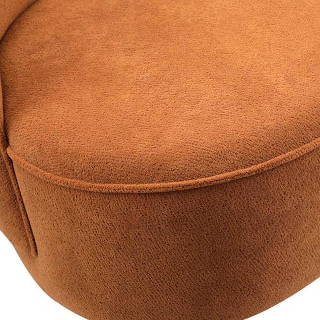 Curved back lounge chair in rich terracotta fabric with plush cushioning and a rounded base – a stylish, commercial-grade seating option built for durability in commercial hotels, lobbies, lounge or reception areas